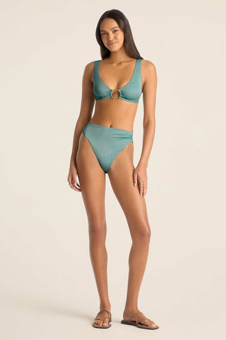 Woman wearing a metallic aqua bikini top with an O ring detail on the front with matching swim bottoms