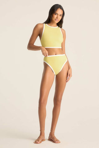 Woman wearing a high neck yellow swim top with matching swim bottoms and white trim