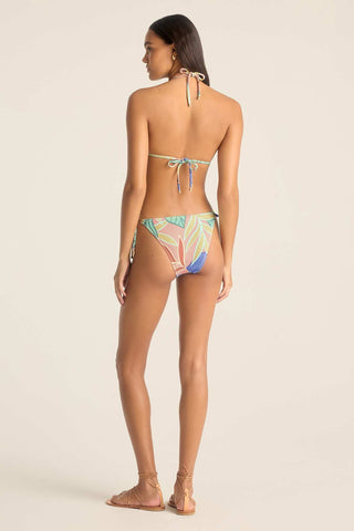 Woman turned away wearing a strong bikini top with a jungle print and matching swim bottoms