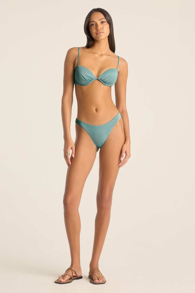 Woman wearing a metallic aqua bandeau swim top with matching swim bottoms 