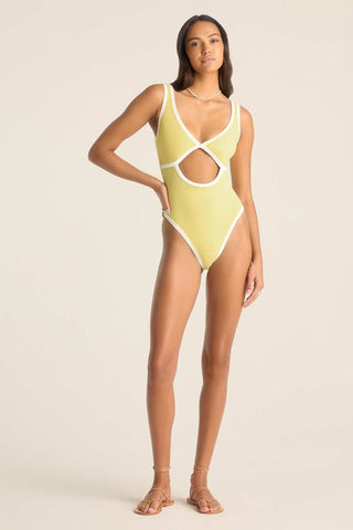 Woman wearing a yellow one-piece swimsuit with white trim